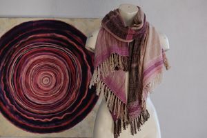 Handwoven scarf naturally dyed shades of pink and fuchsia on a white mannequin in a white gallery space