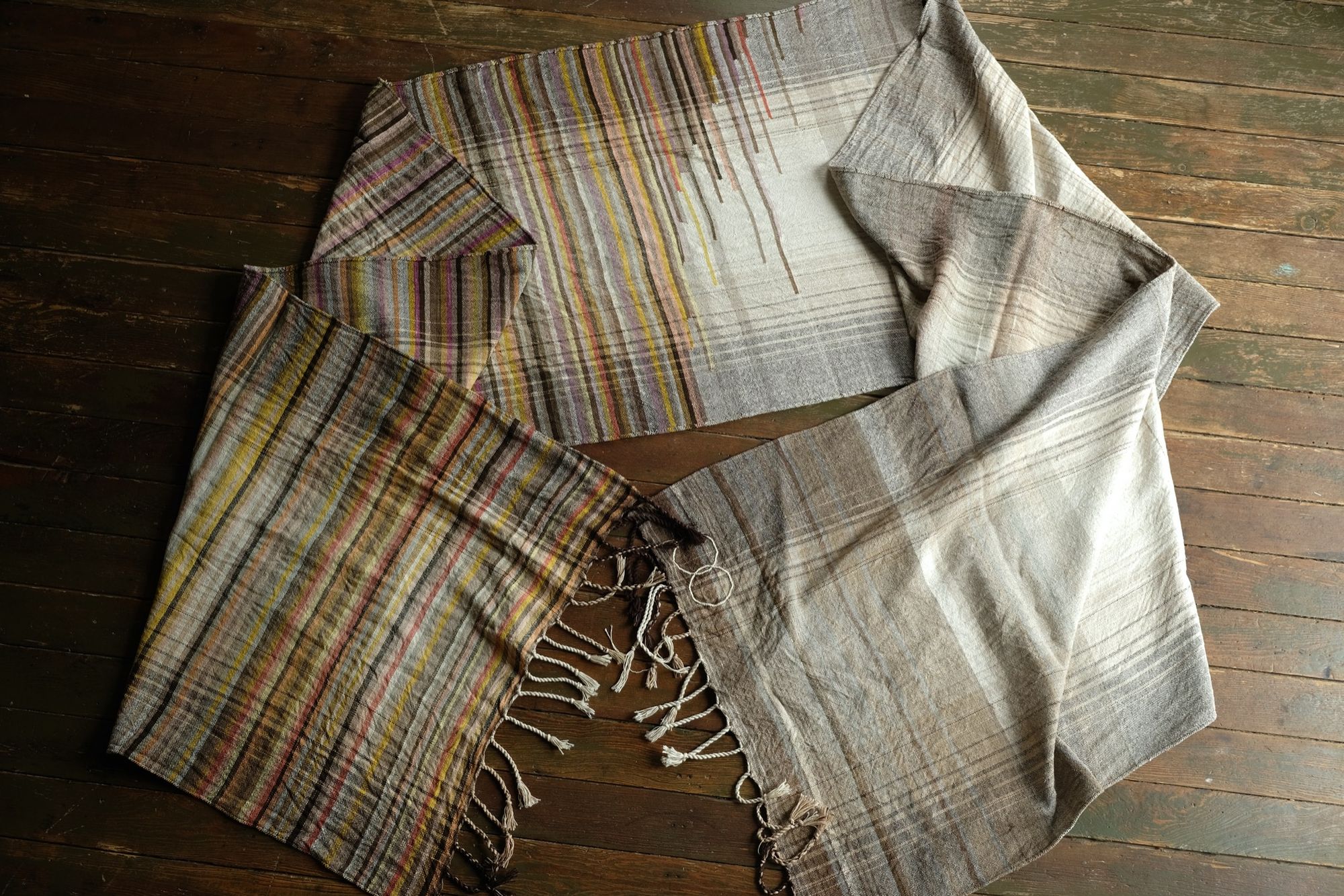 handwoven raw silk fabric with softly colored lines woven into it in browns, red, yellow, pink