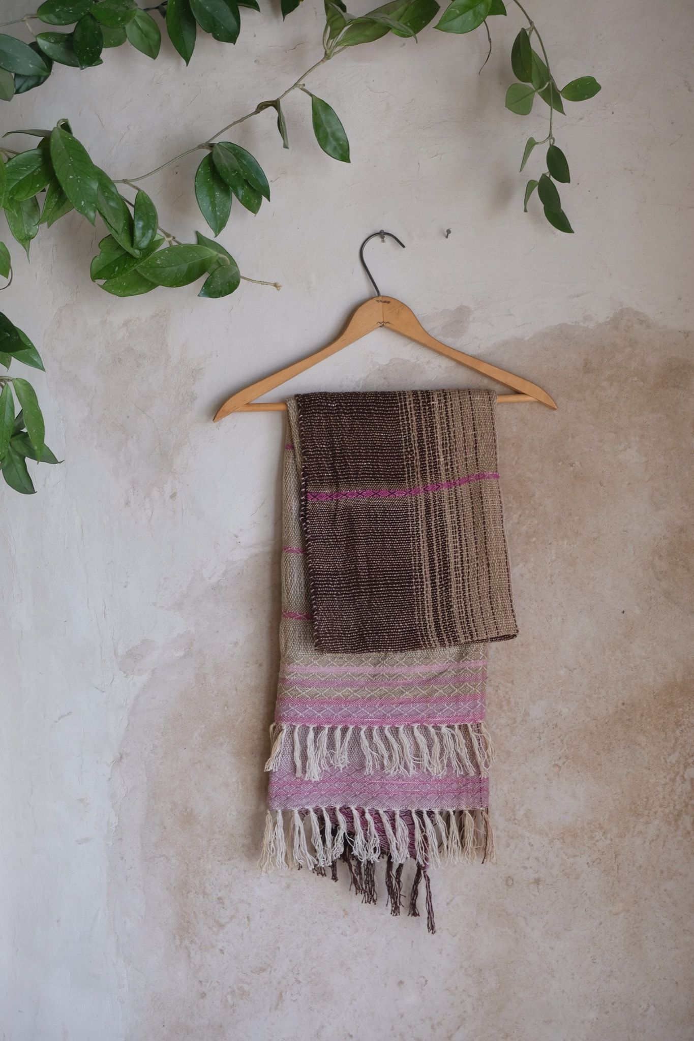 Naturally dyed brown, pink and purple handwoven scarf on hanger