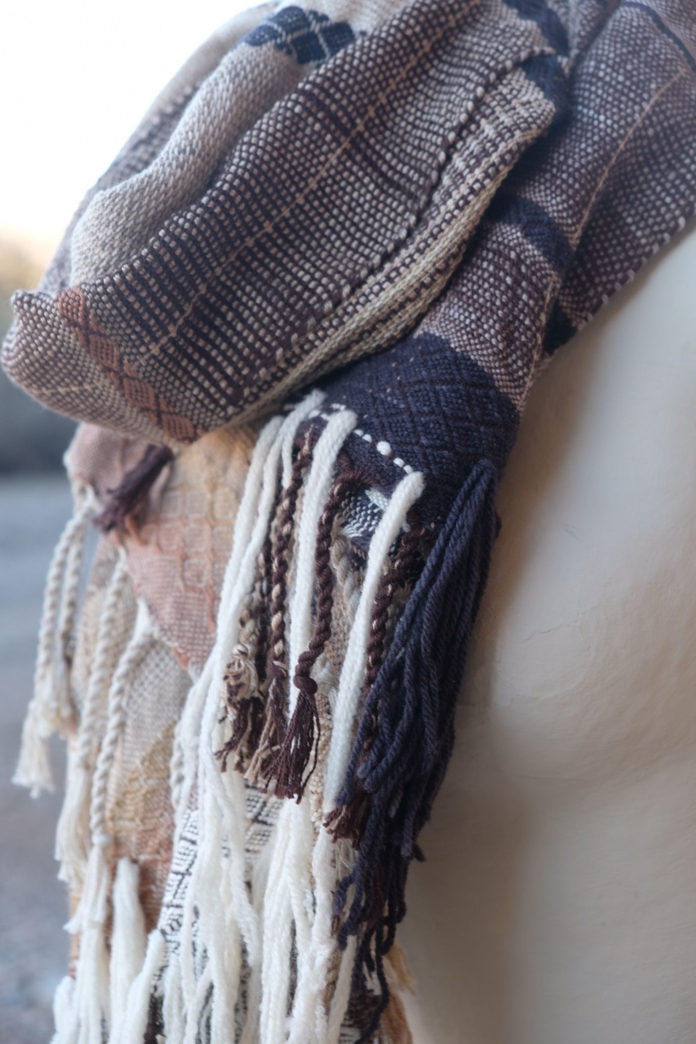 detail of Black, tan & White handwoven merino Etherial Scarf on a white mannequin