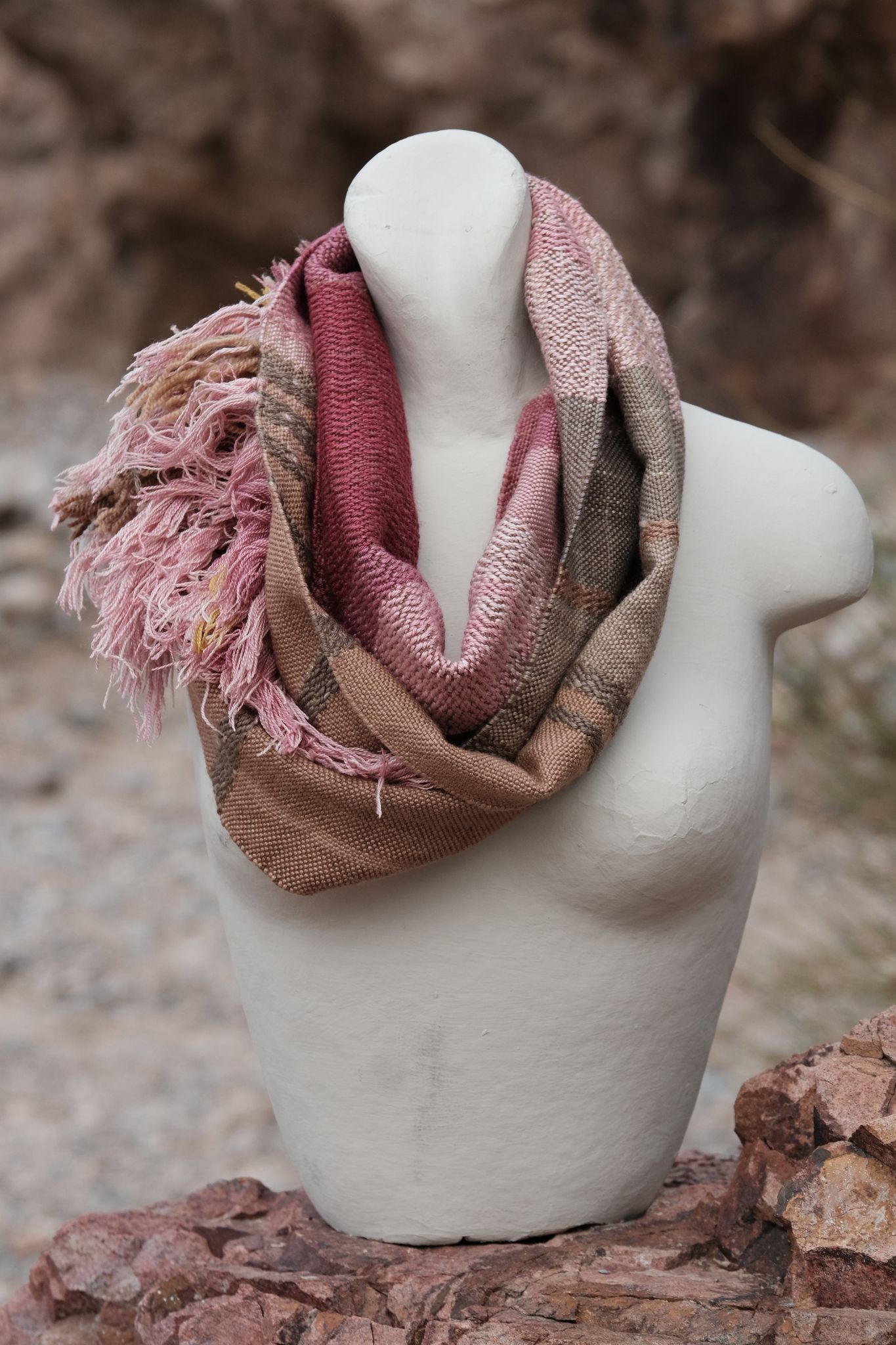 pink and brown handwoven scarf on white mannequin 
