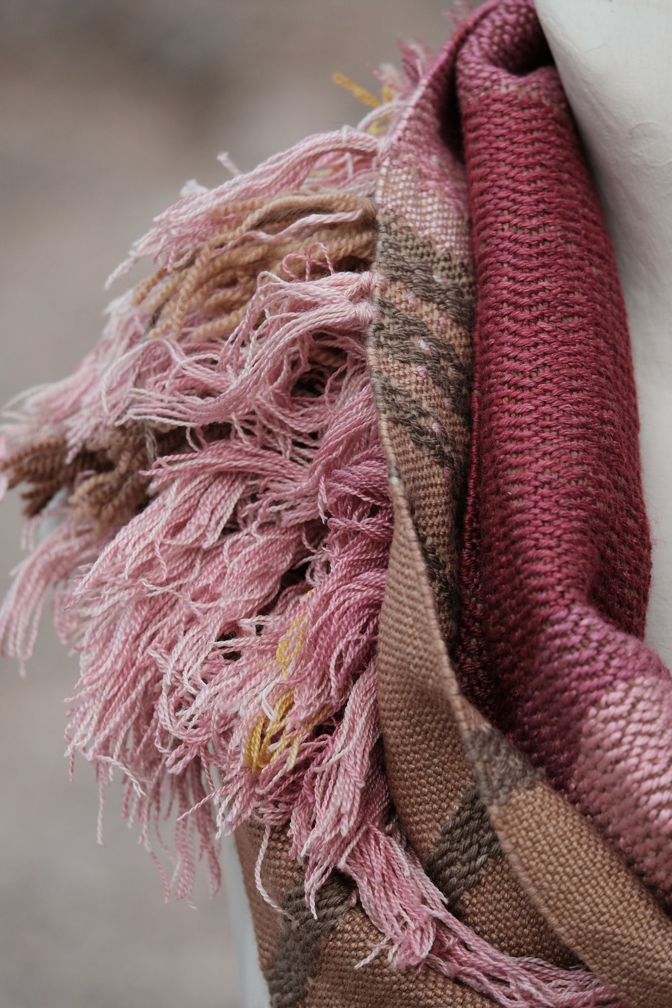 pink and brown handwoven scarf on white mannequin 