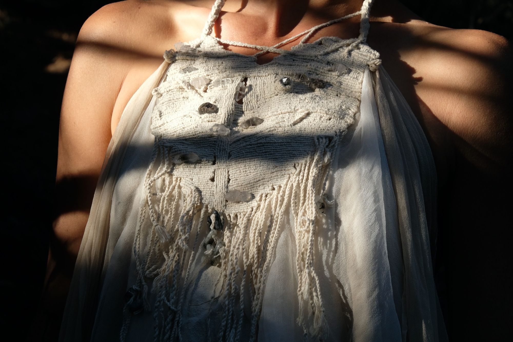 detail of woman wearing white layered silk handmade dress
