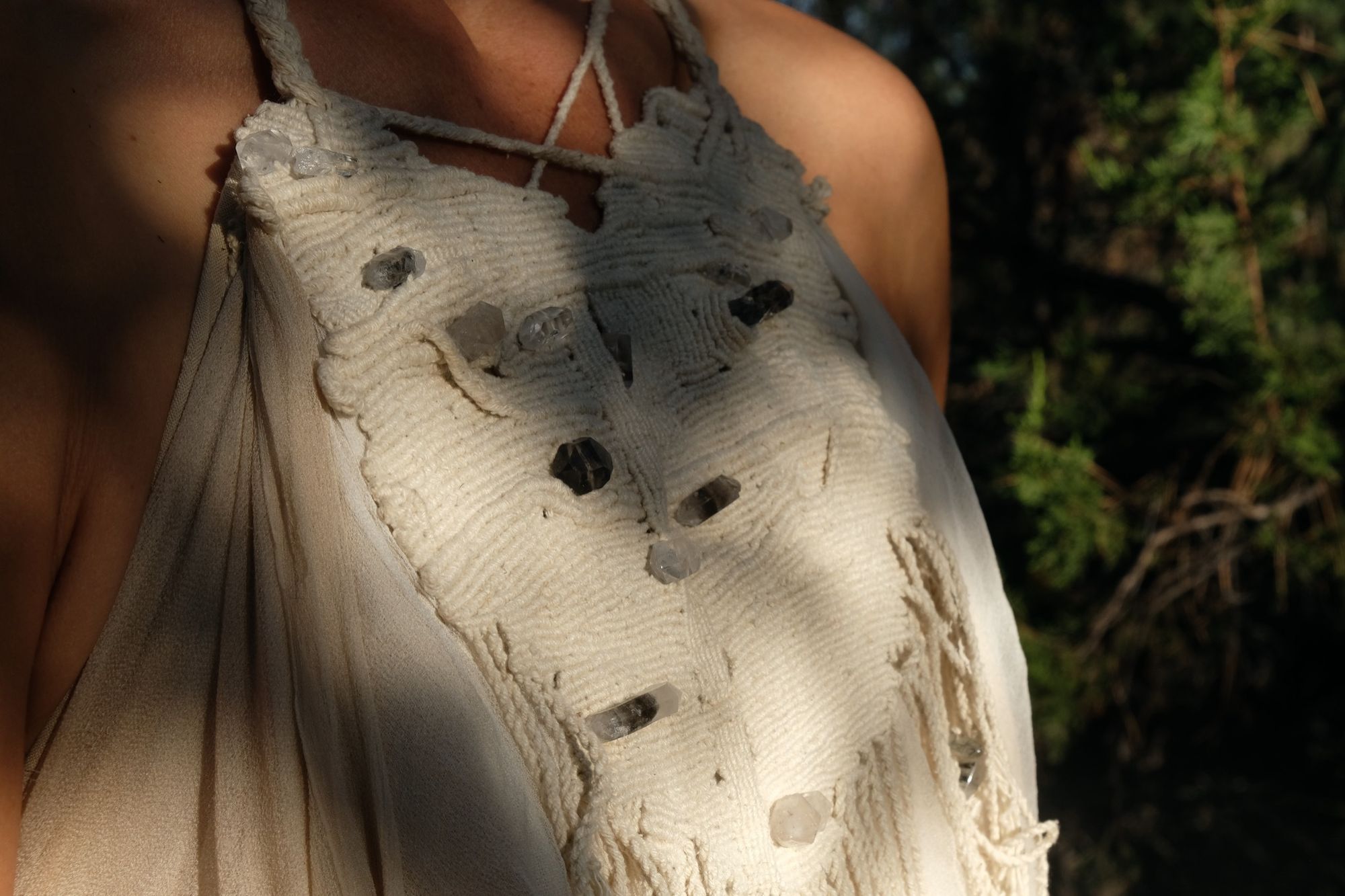 detail of woman wearing white layered silk handmade dress