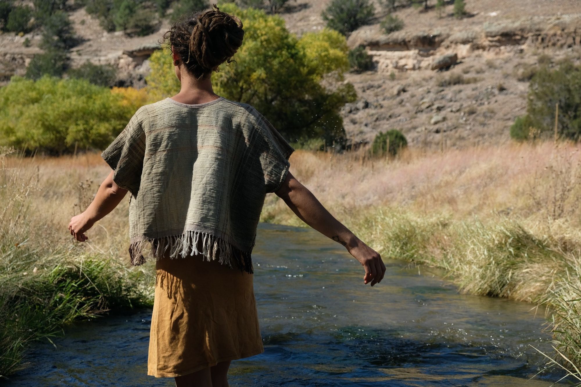 woman wearing tan and dark brown Handspun handwoven Colorgrown Cotton Box Top while standing in a creek