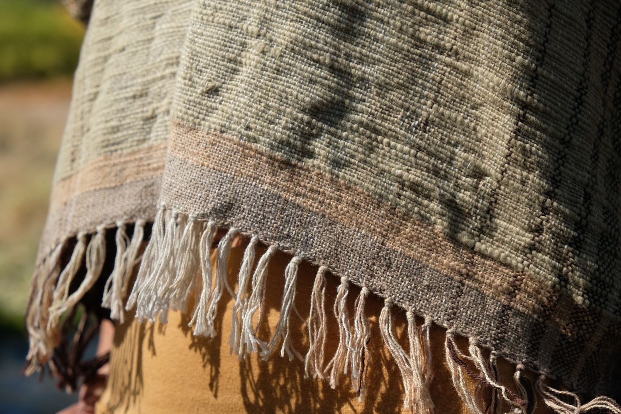 detail of woman wearing tan and dark brown Handspun handwoven Colorgrown Cotton Box Top while standing in a creek