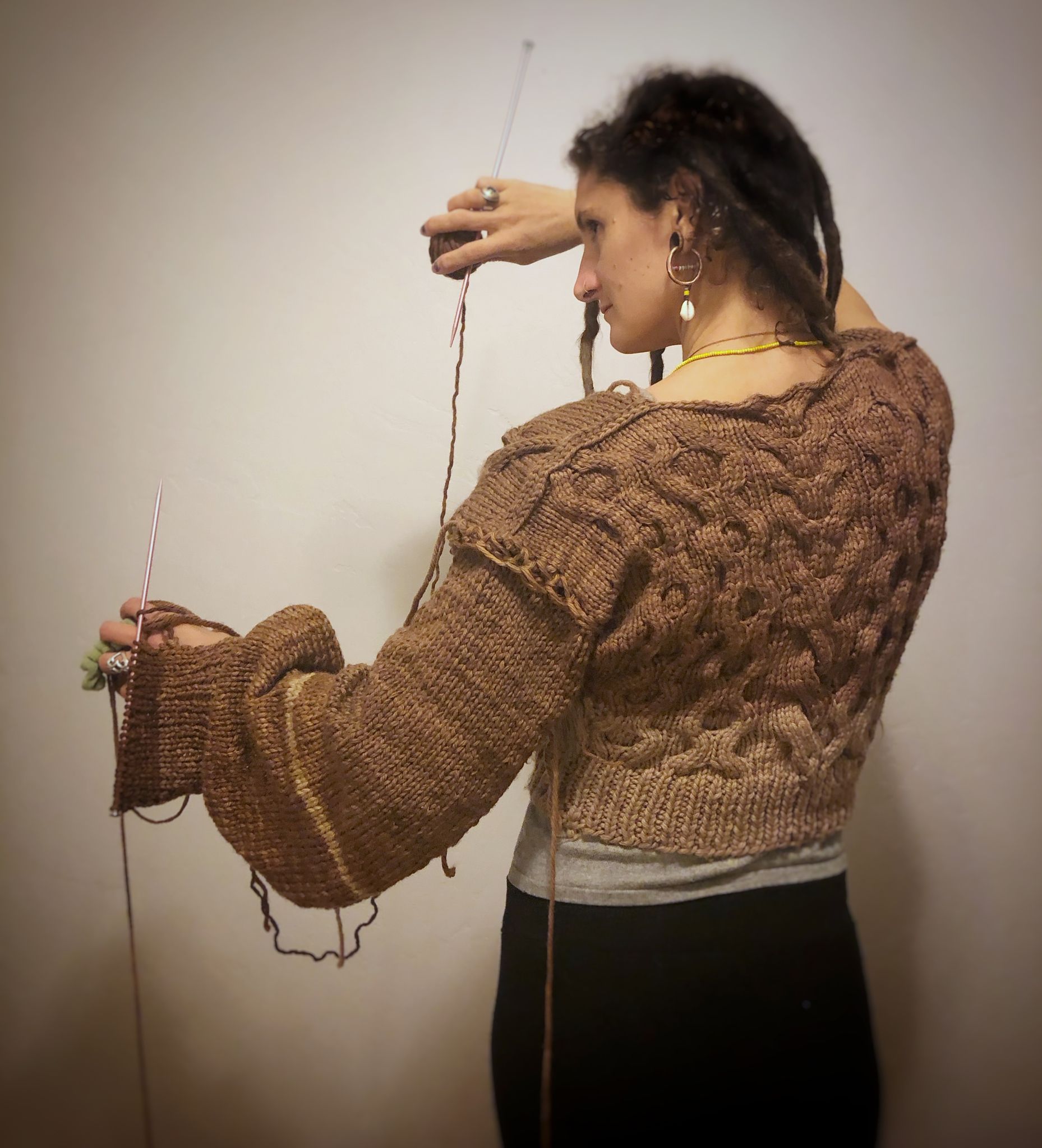 woman wearing Hand knit black walnut dyed sweater in progress