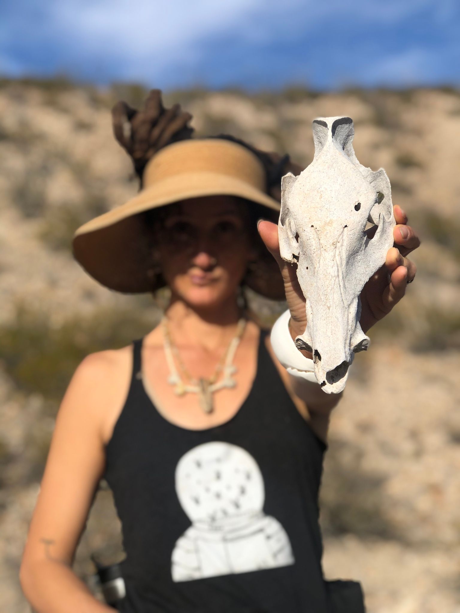 Woman holding a Javelina skull 