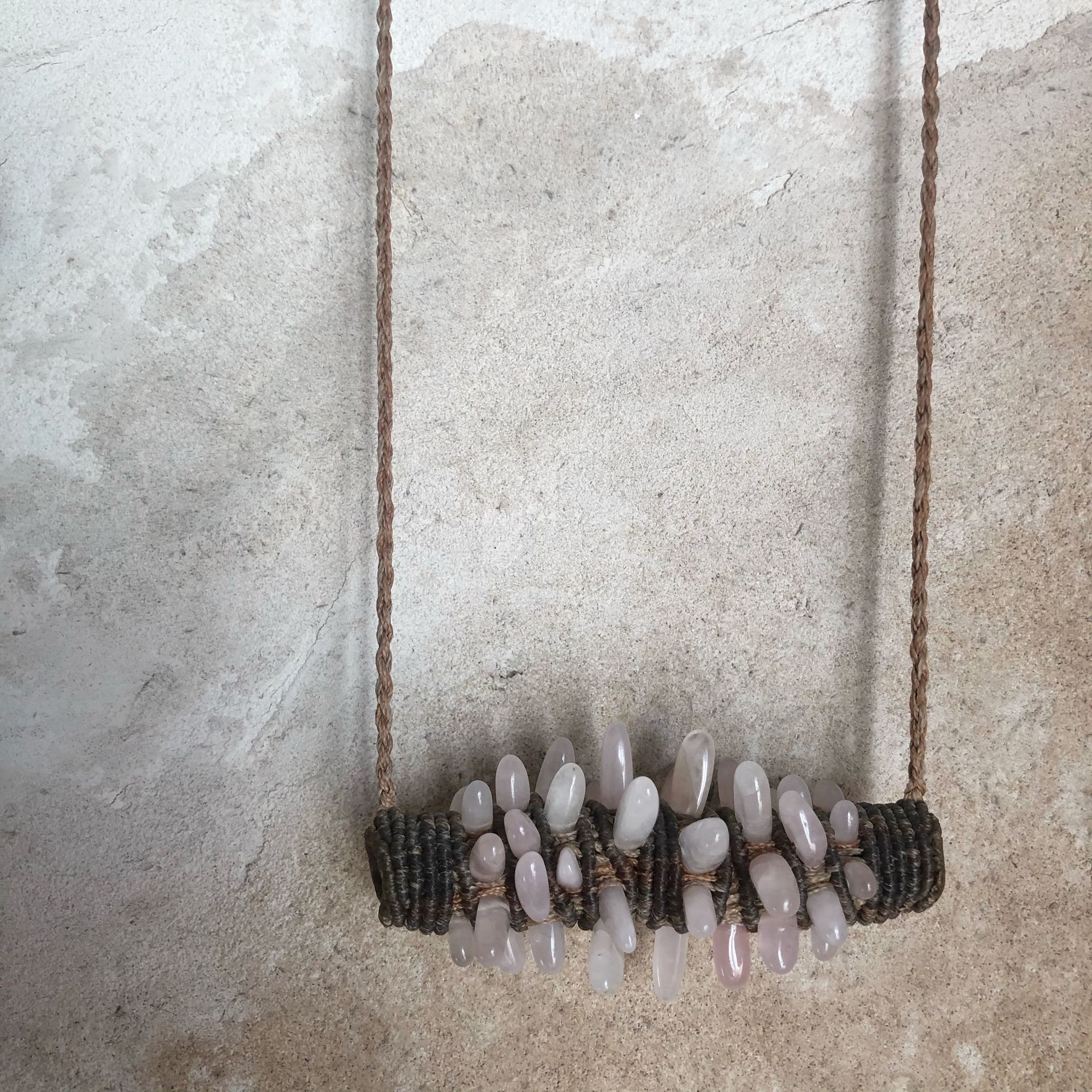 Freeform knot work tube necklace with rose quartz spears protruding from it 