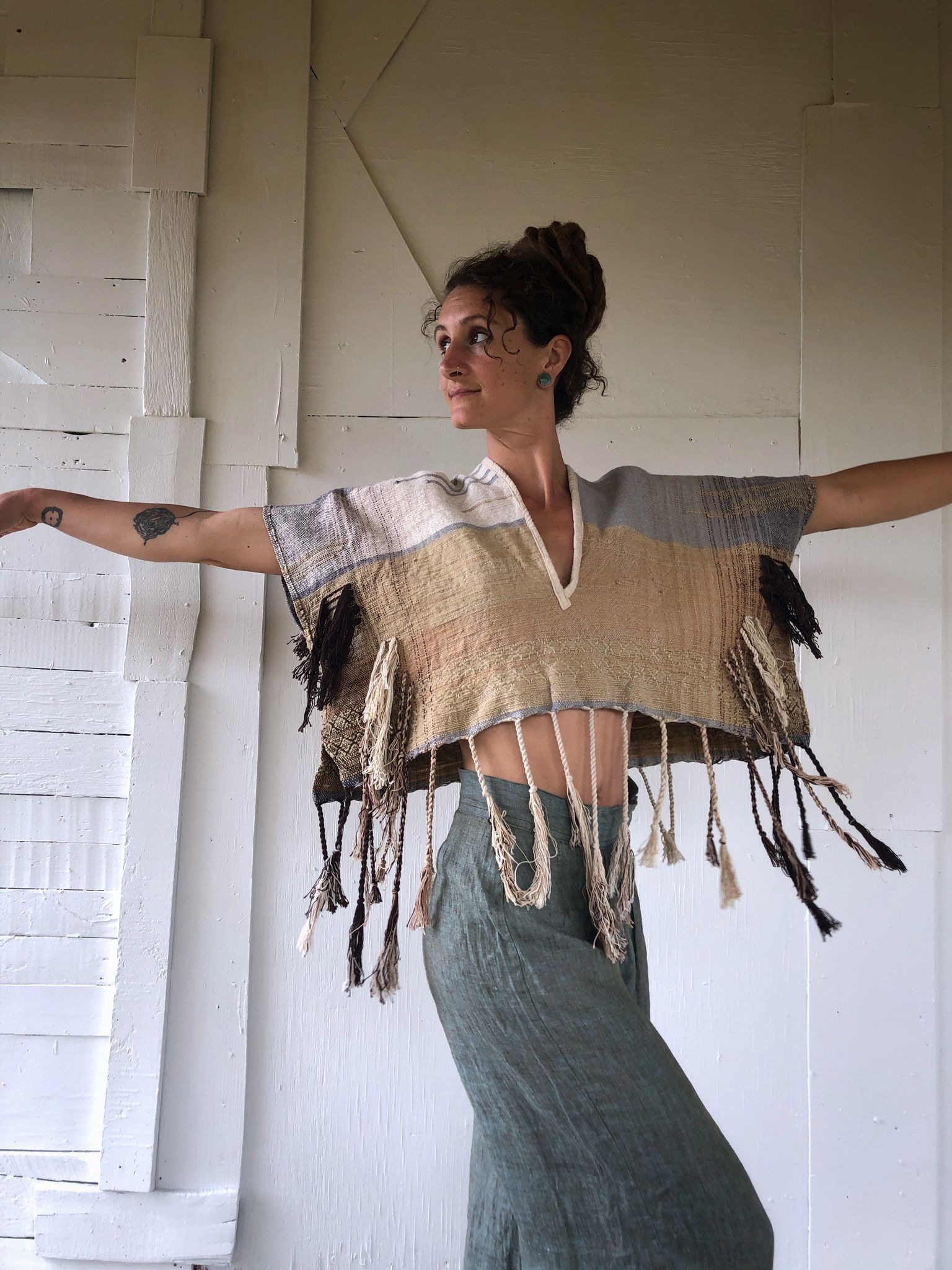 Woman wearing Handwoven blue, tan and brown Handspun Cotton box Top with blue pants