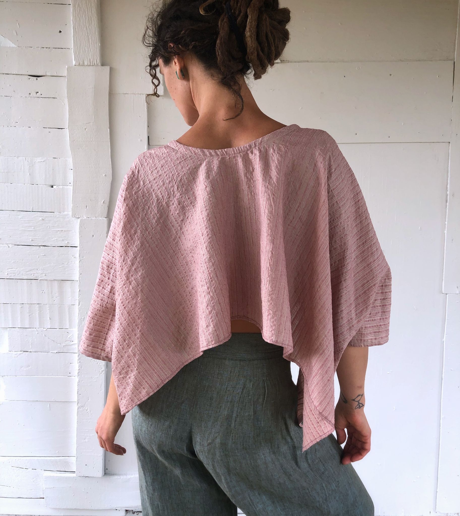 woman wearing Pink striped hand sewn silk shirt and blue pants