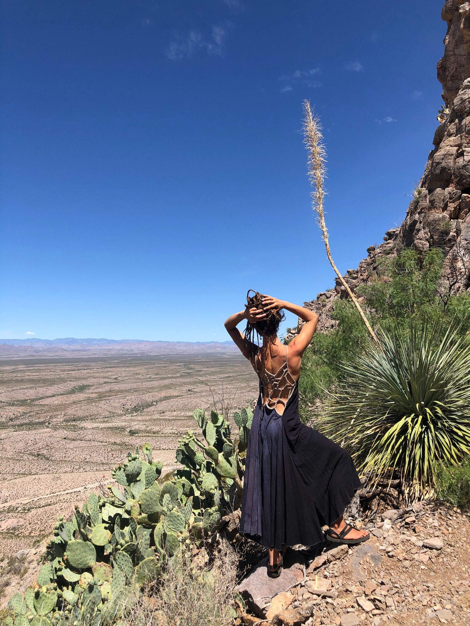 Woman wearing blue and grey dress in the desert