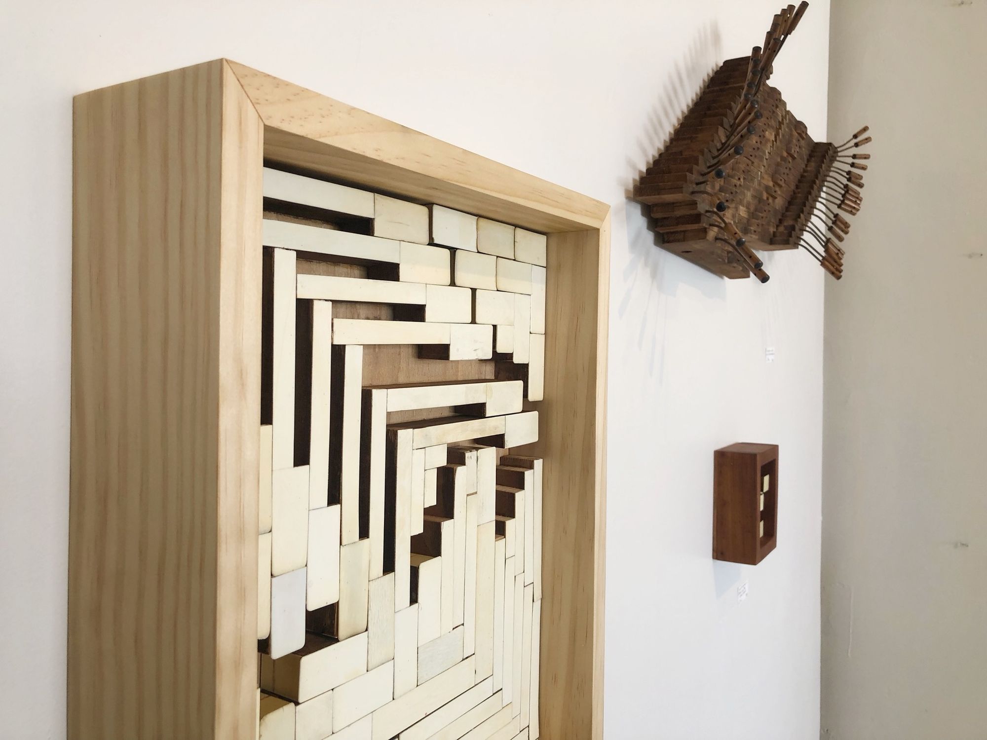 Wall mounted abstract sculpture in light wood frame made from Ivory piano keys