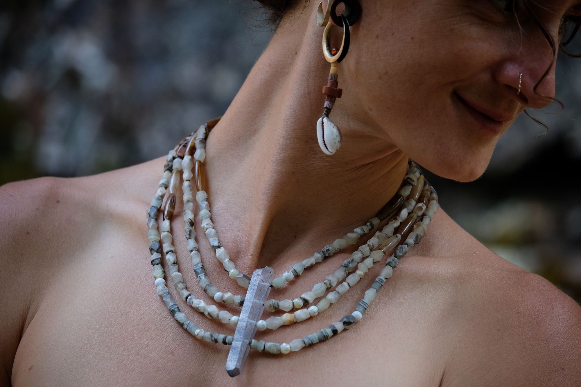 Woman wearing four strand faceted jade and quartz point necklace