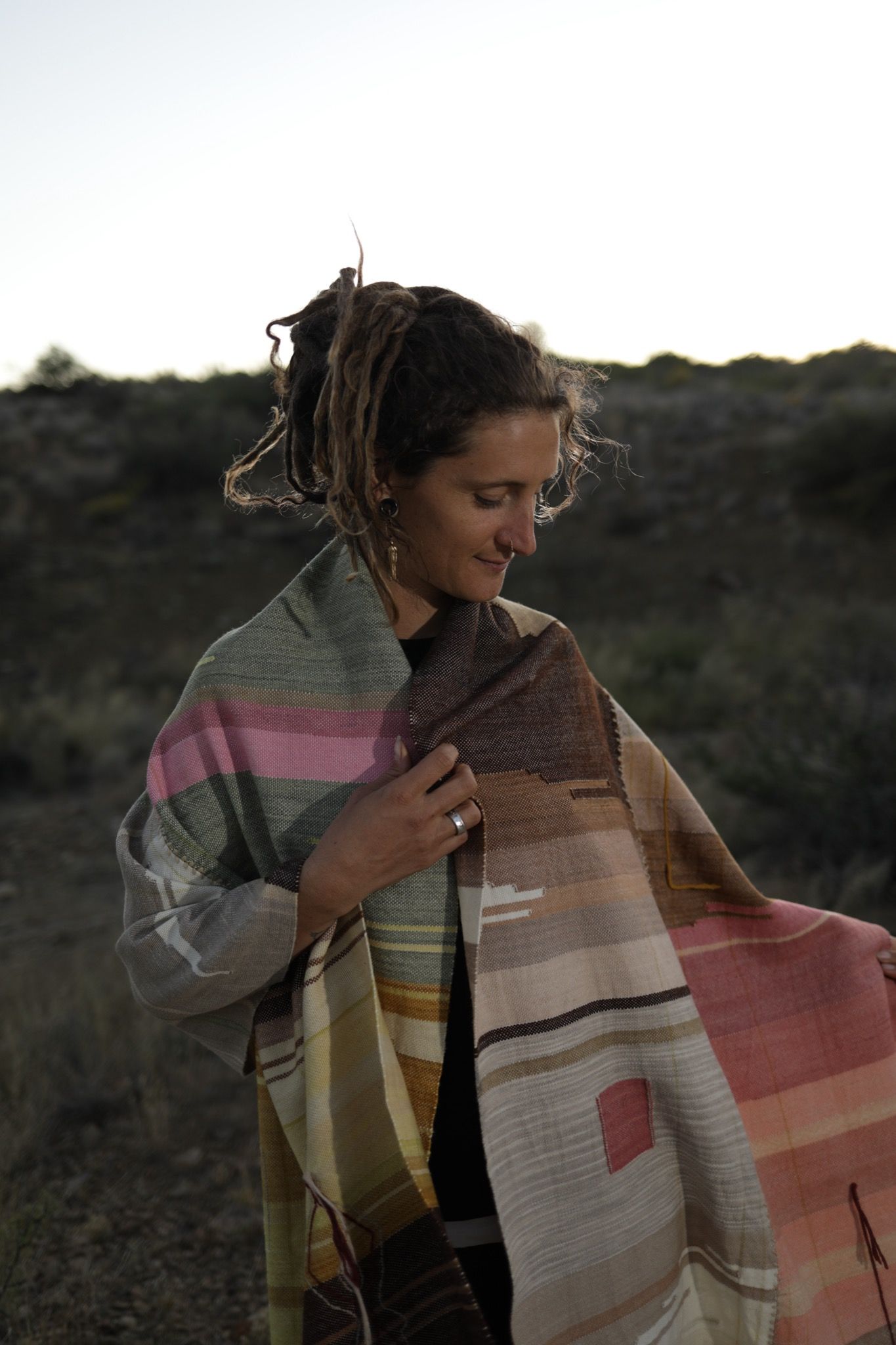 Woman wearing Handwoven Naturally Dyed Merino Blanket in the desert