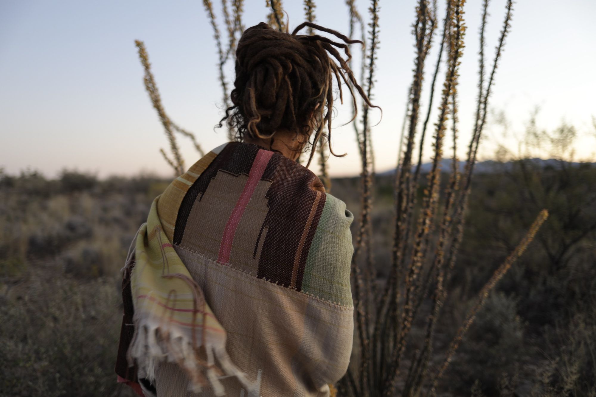 Woman wearing Handwoven Naturally Dyed Merino Blanket in the desert