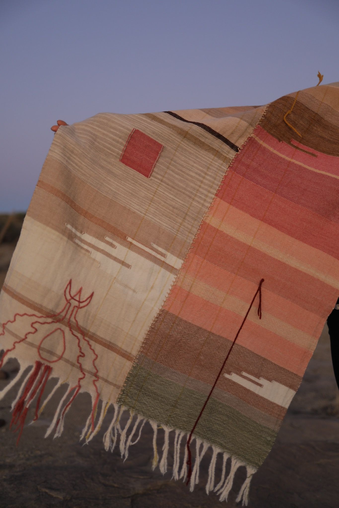 Woman wearing Handwoven Naturally Dyed Merino Blanket in the desert