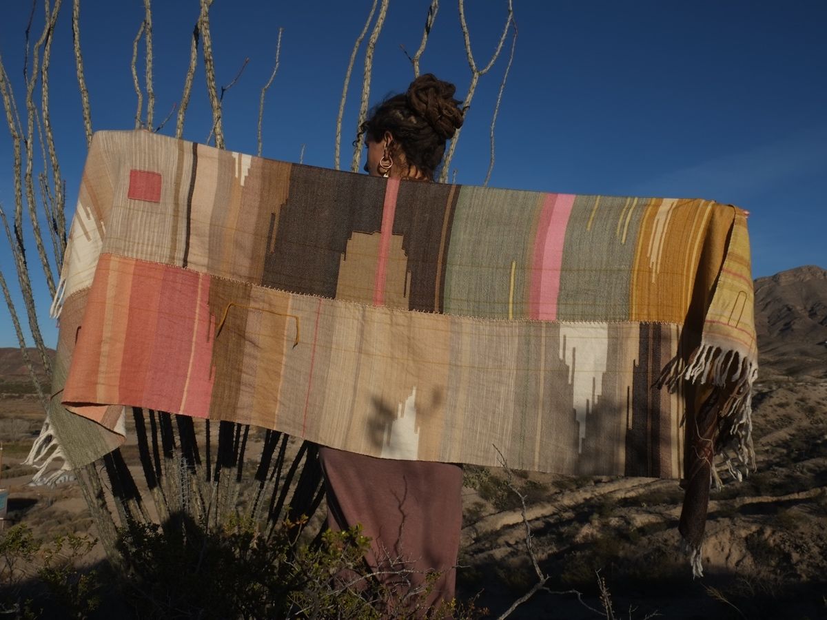 Woman wearing Handwoven Naturally Dyed Merino Blanket in the desert