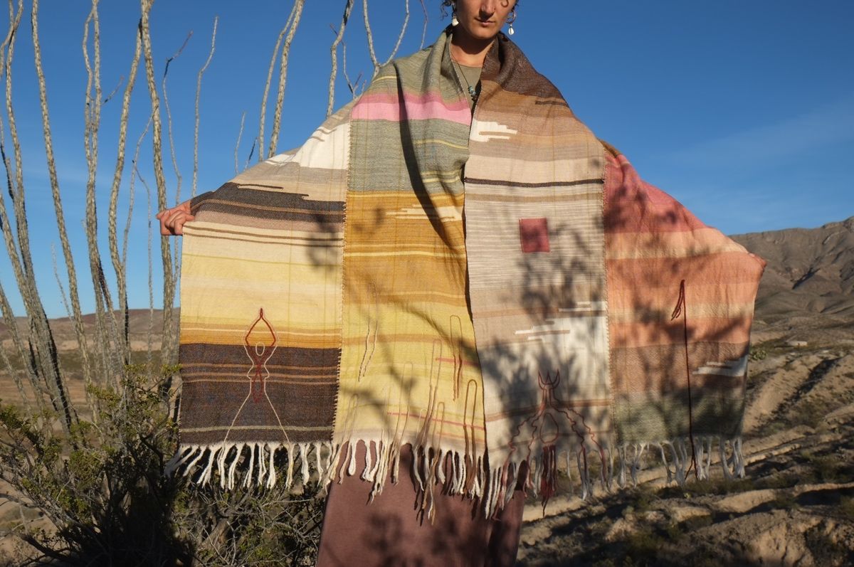 Woman wearing Handwoven Naturally Dyed Merino Blanket in the desert