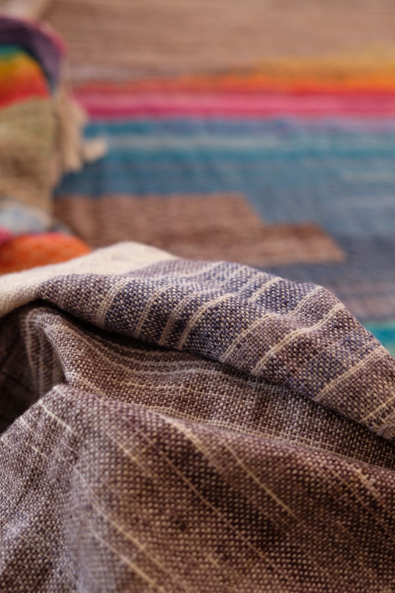 Handwoven raw silk fabric with textures diamond weave in browns, tans, purples, blues, yellows, pink and orange