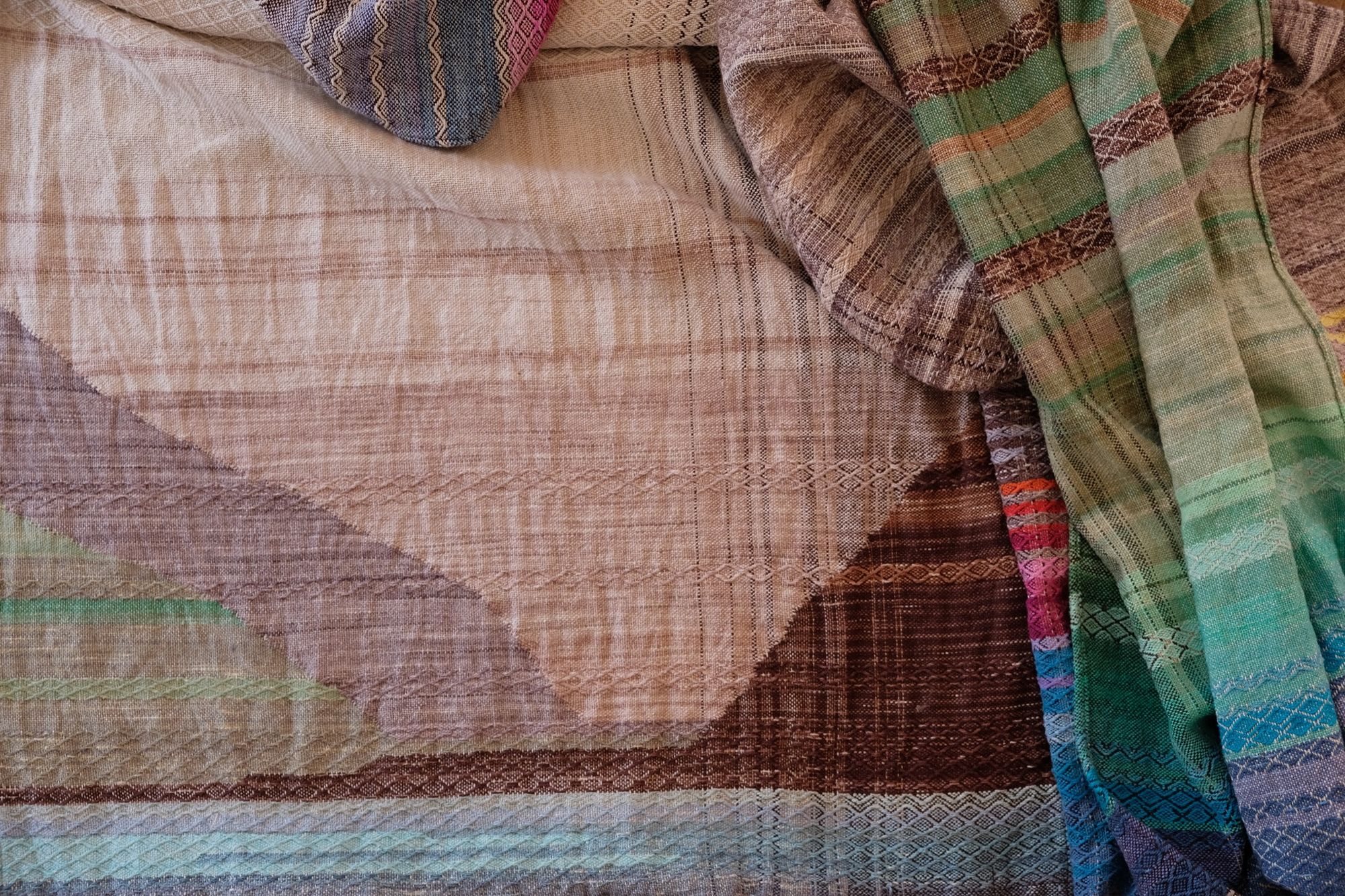 Handwoven raw silk fabric with textures diamond weave in browns, tans, purples, blues, yellows, pink and orange