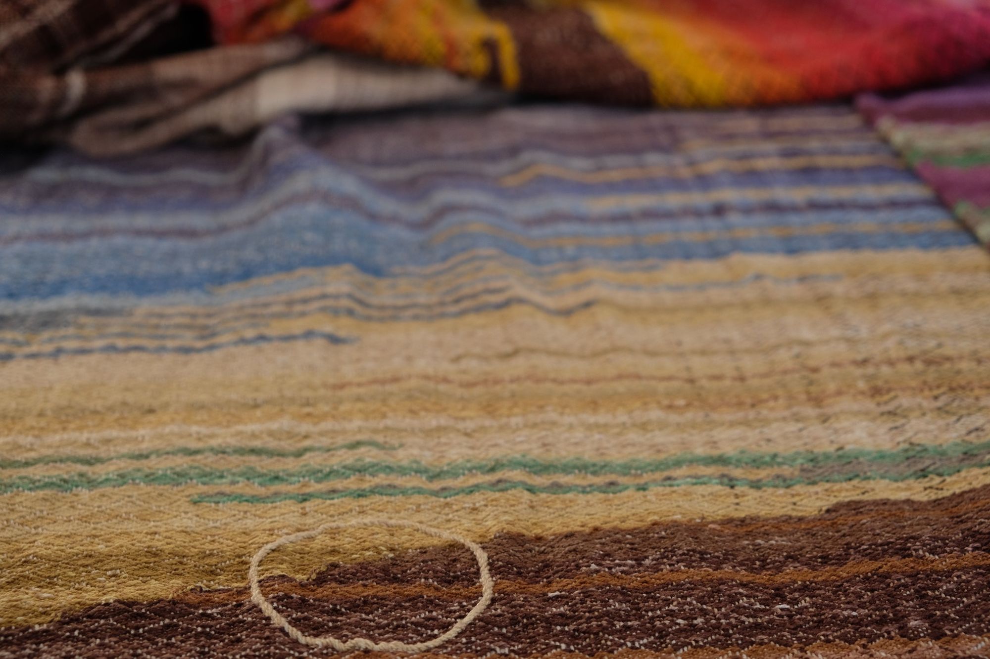 Handwoven, highly textures Diamond pattern fabric in every color of the rainbow, with natural browns and tans with a circle