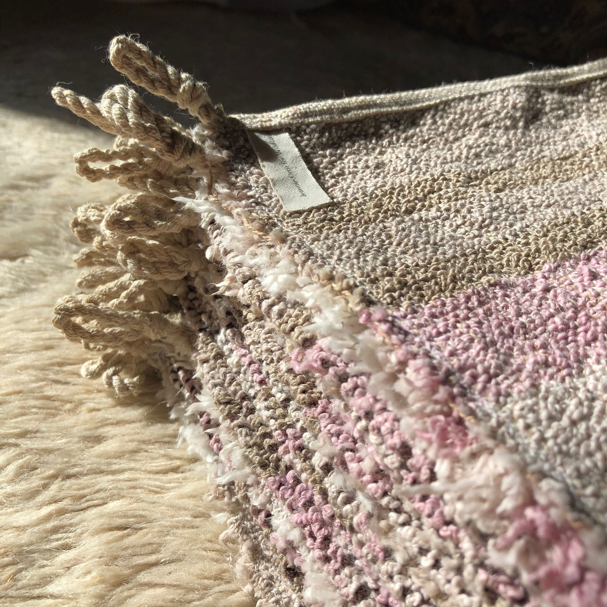 Detail of a stack of handwoven pink, white and brown linen-cotton washcloths