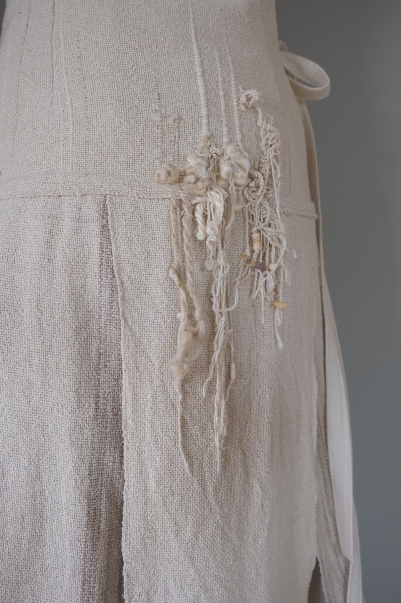 detail of handwoven highly textured fringe wedding skirt