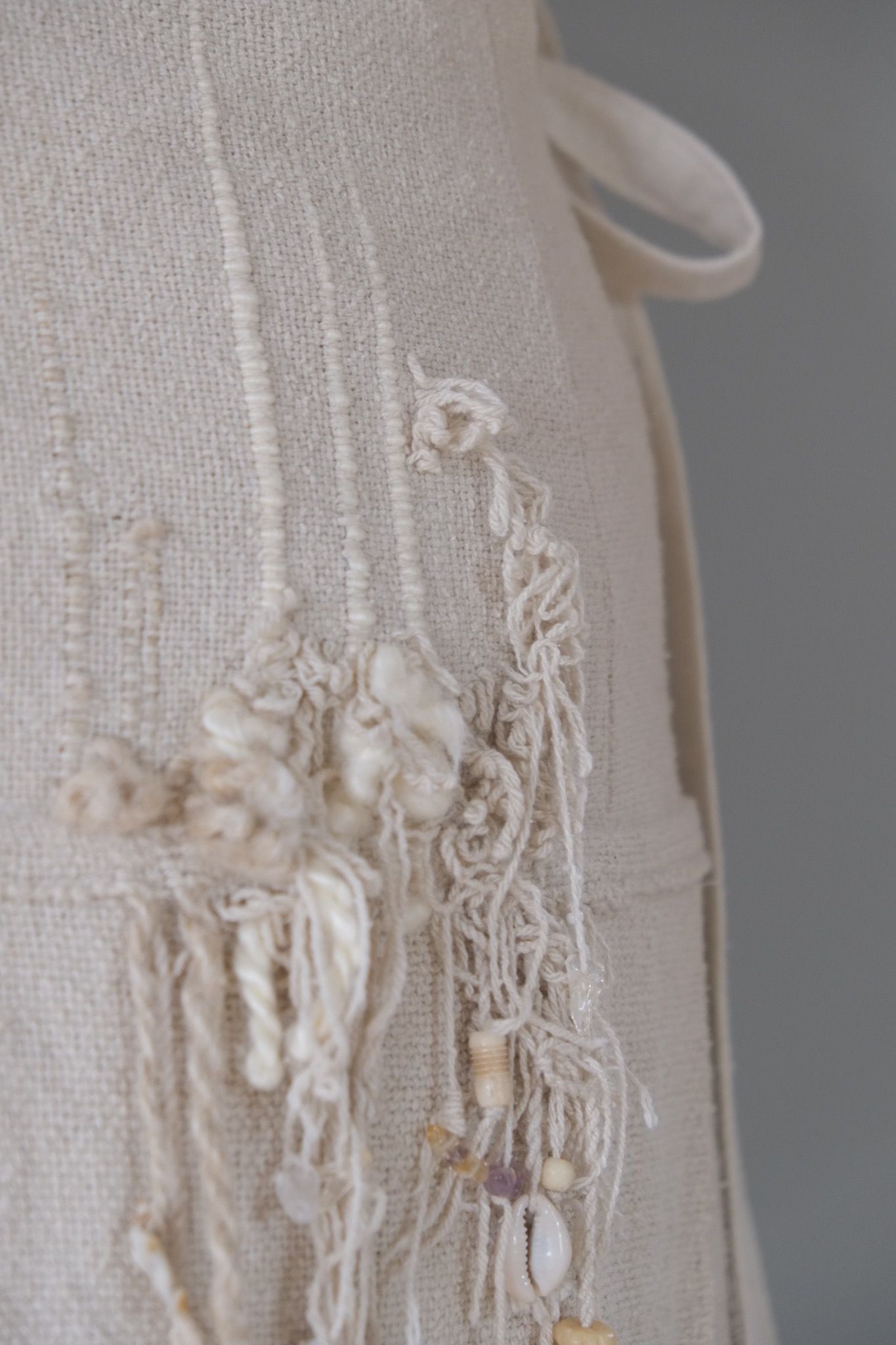 detail of handwoven highly textured fringe wedding skirt