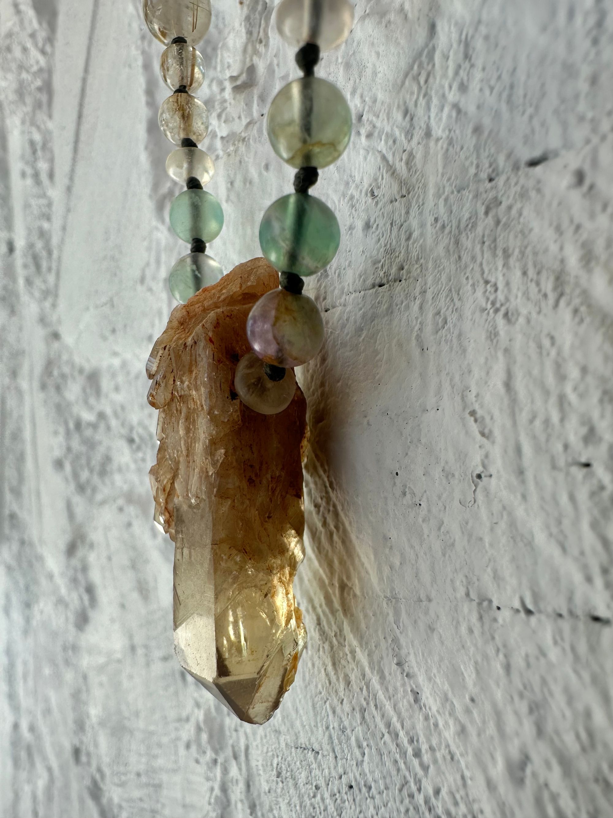  A necklace of Yellow citrine, Purple and green fluorite and brilliant golden rutile quartz