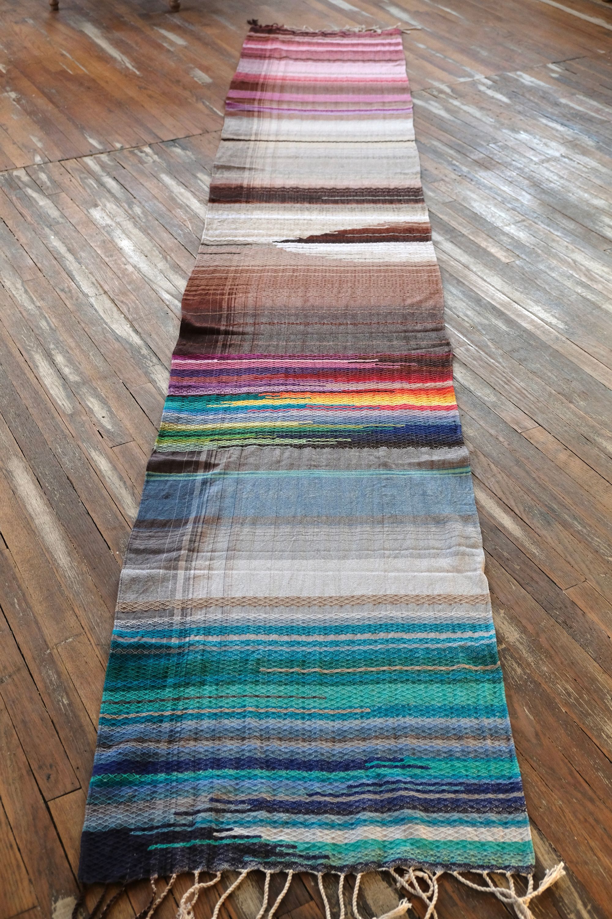 5 m of head oven rainbow colored fabric layers on a wooden floor