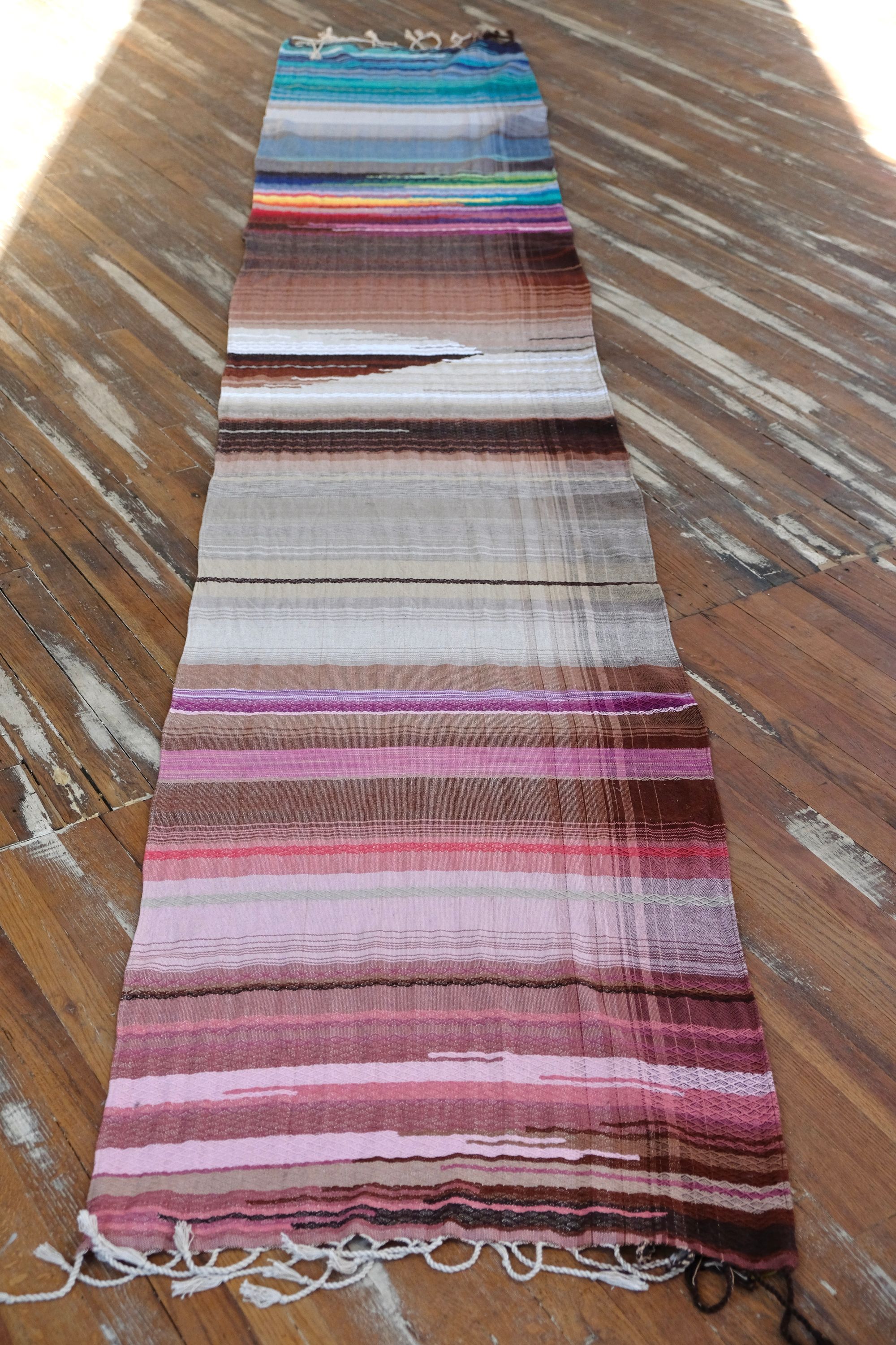 5 m of head oven rainbow colored fabric layers on a wooden floor