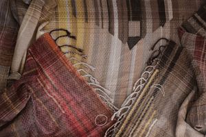 Handwoven raw silk fabric in subtle tones of brown, tan, yellow and burned red and orange 