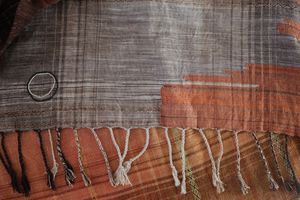 Orange and brown silk weaving with a moon woven into it