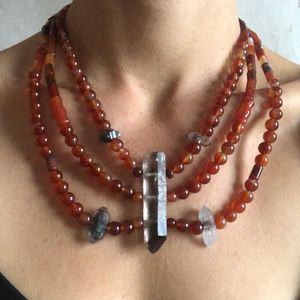 Woman wearing smoky quartz and red carnelian stone necklace