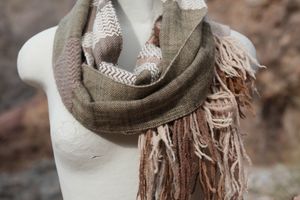 Highly textured and fringy wool and cashmere cowl scarf in green, tan and brown on a white mannequin