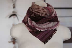 Handwoven purple, maroon, burgundy and white neck scarf on a white mannequin. 