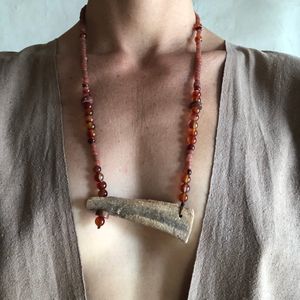 woman wearing Necklace made of Stalaktit & red Carnelian, glass and bauxite beads