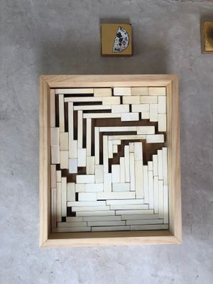 Wall mounted abstract sculpture in light wood frame made from Ivory piano keys