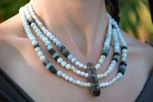 woman wearing Smoky quartz, fire agate, Amazonite, labradorite, aventurine and rutilated quartz necklace