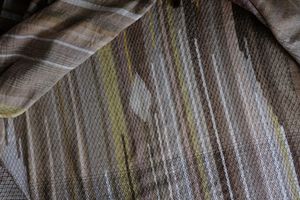 handwoven diamond pattern and geometric details in browns, tan, yellows, whites and pinks