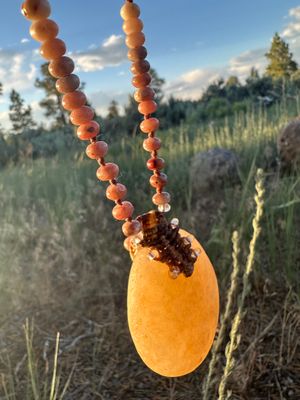 And ocean polished stone necklace glows golden in the sunset