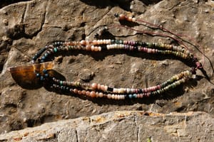 a necklace of luminous semi precious stones in golden citrine, black, dusty pink and deep green